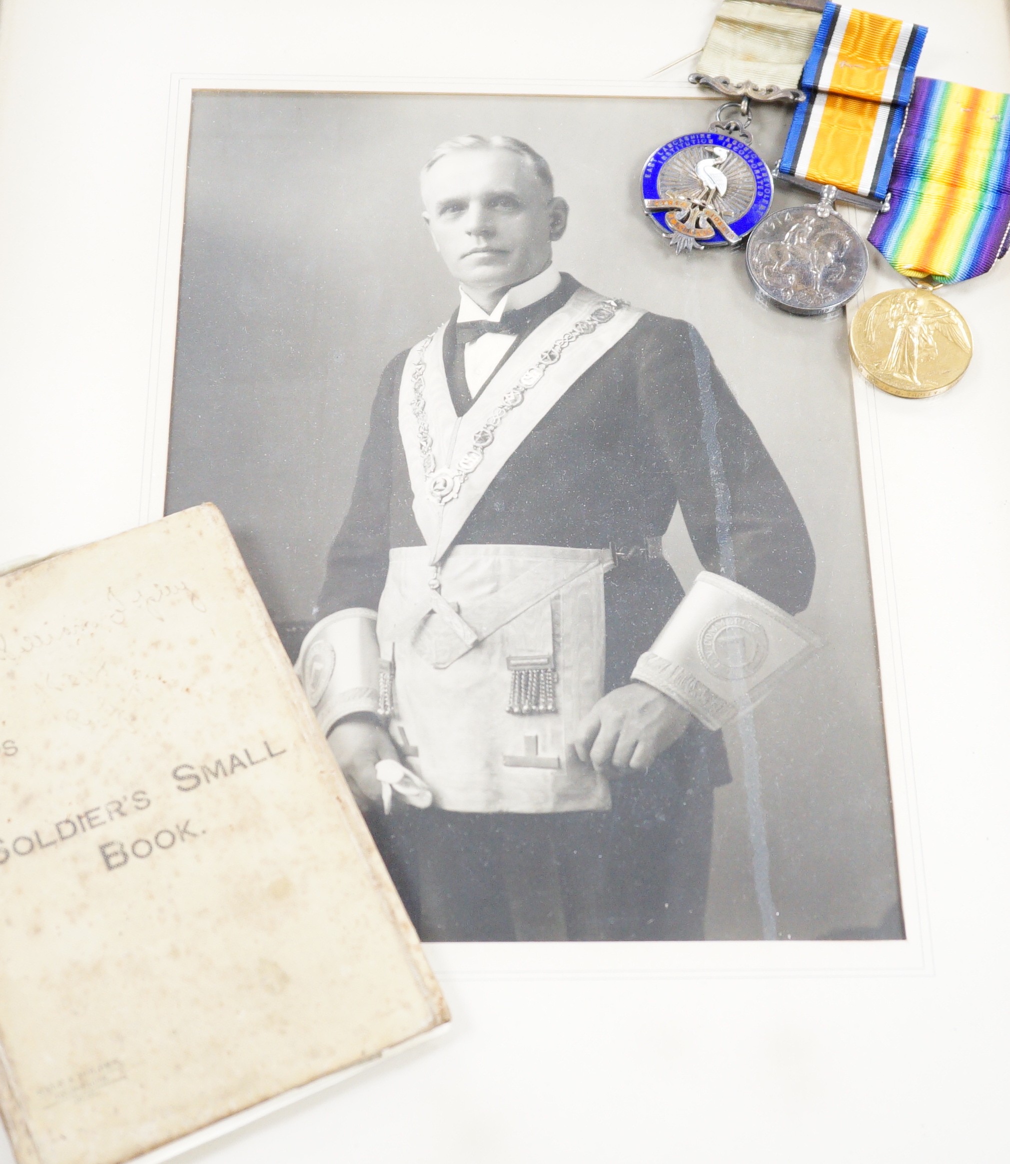 A WWI pair, silver masonic medal and soldier's small book